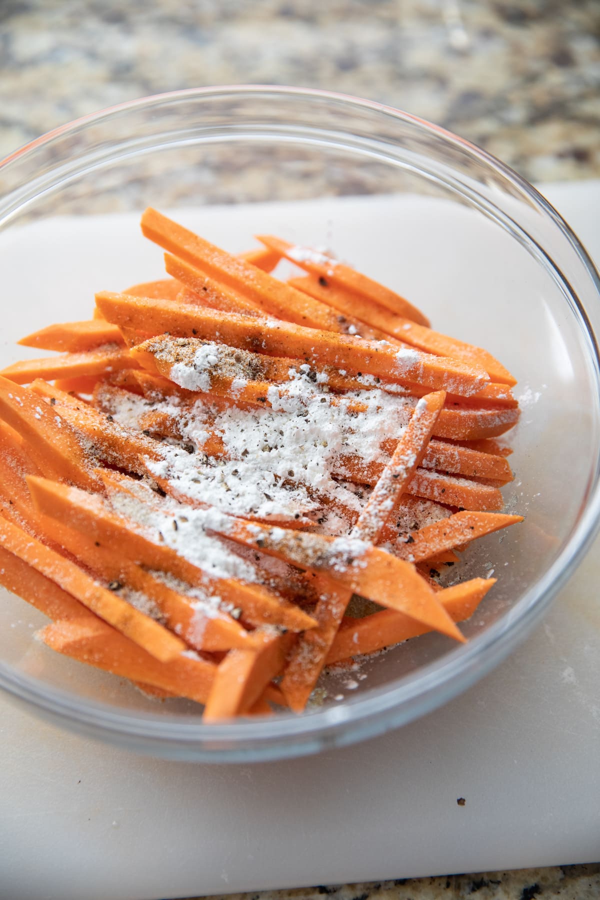 cut sweet potato fries with spices in bowl