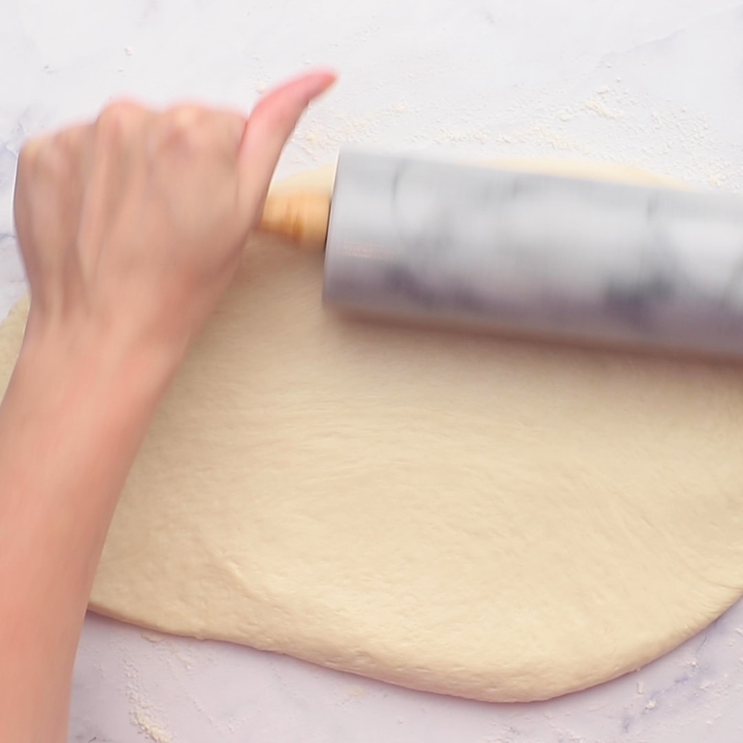 Woman rolling out Apple Fritters dough with rolling pin