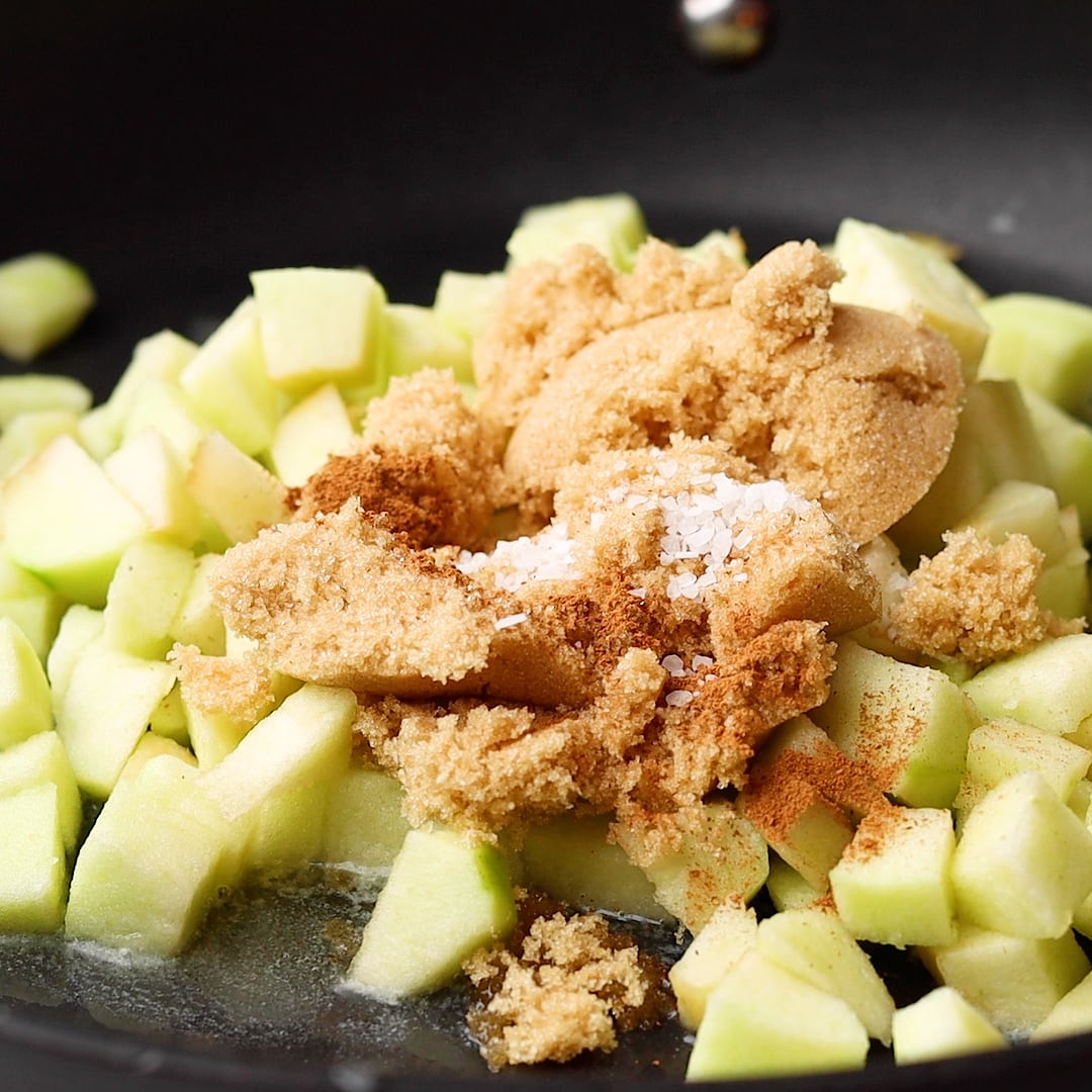 raw apples with brown sugar in pan