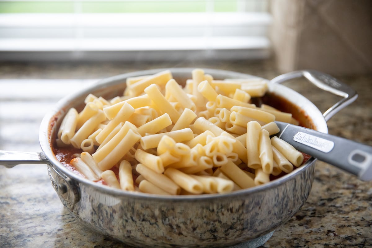 ziti pasta added to deep skillet with sauce