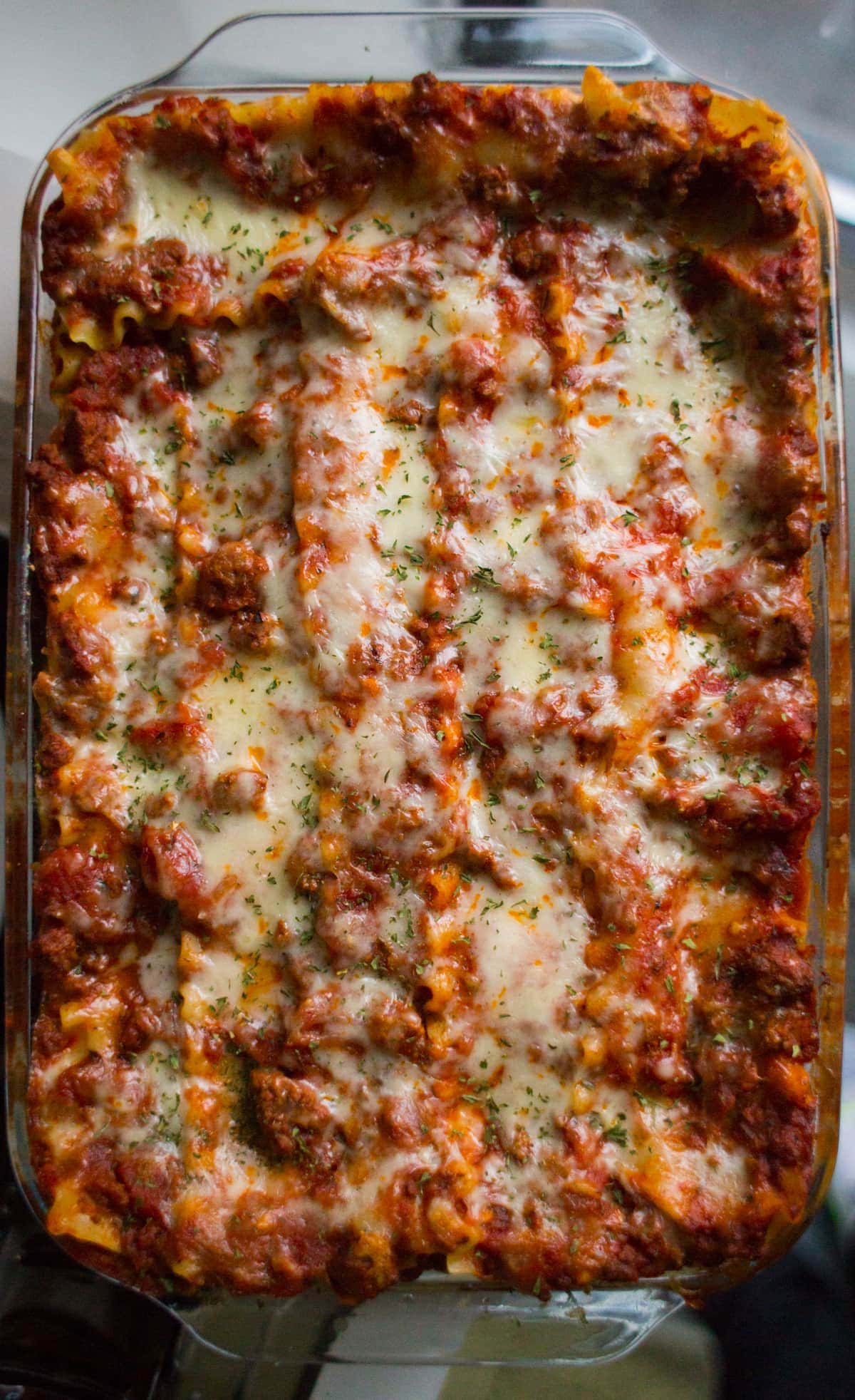 Top down view of baked lasagna in a glass baking dish