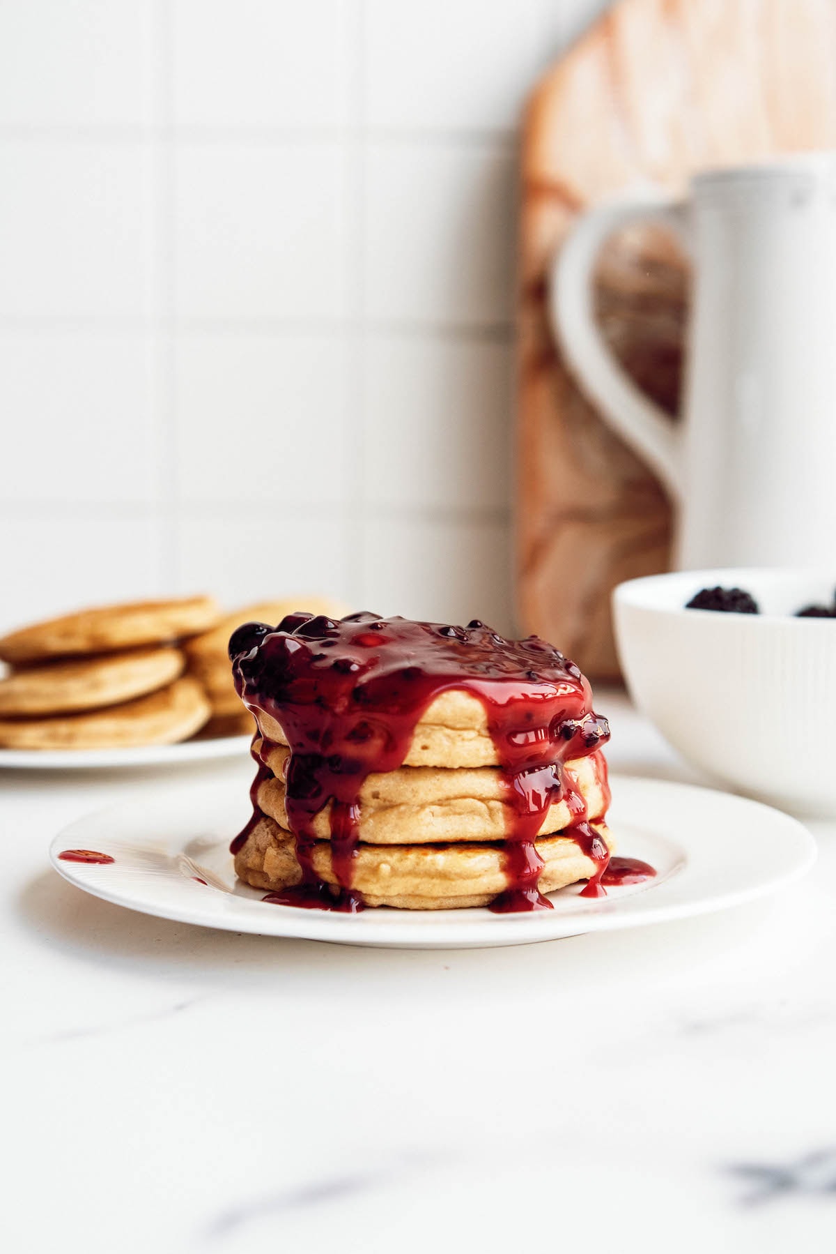 blackberry syrup over stack of pancakes