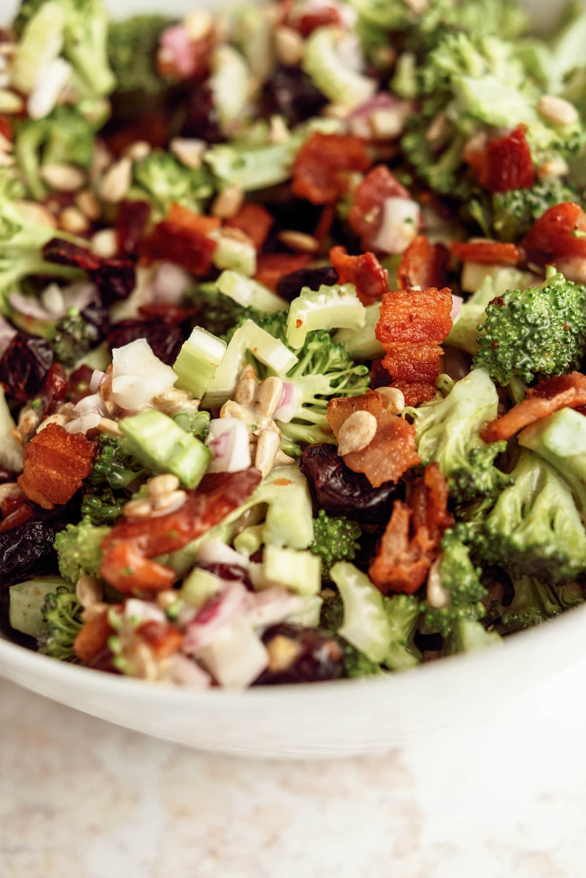 close up view of broccoli salad ingredients in a bowl