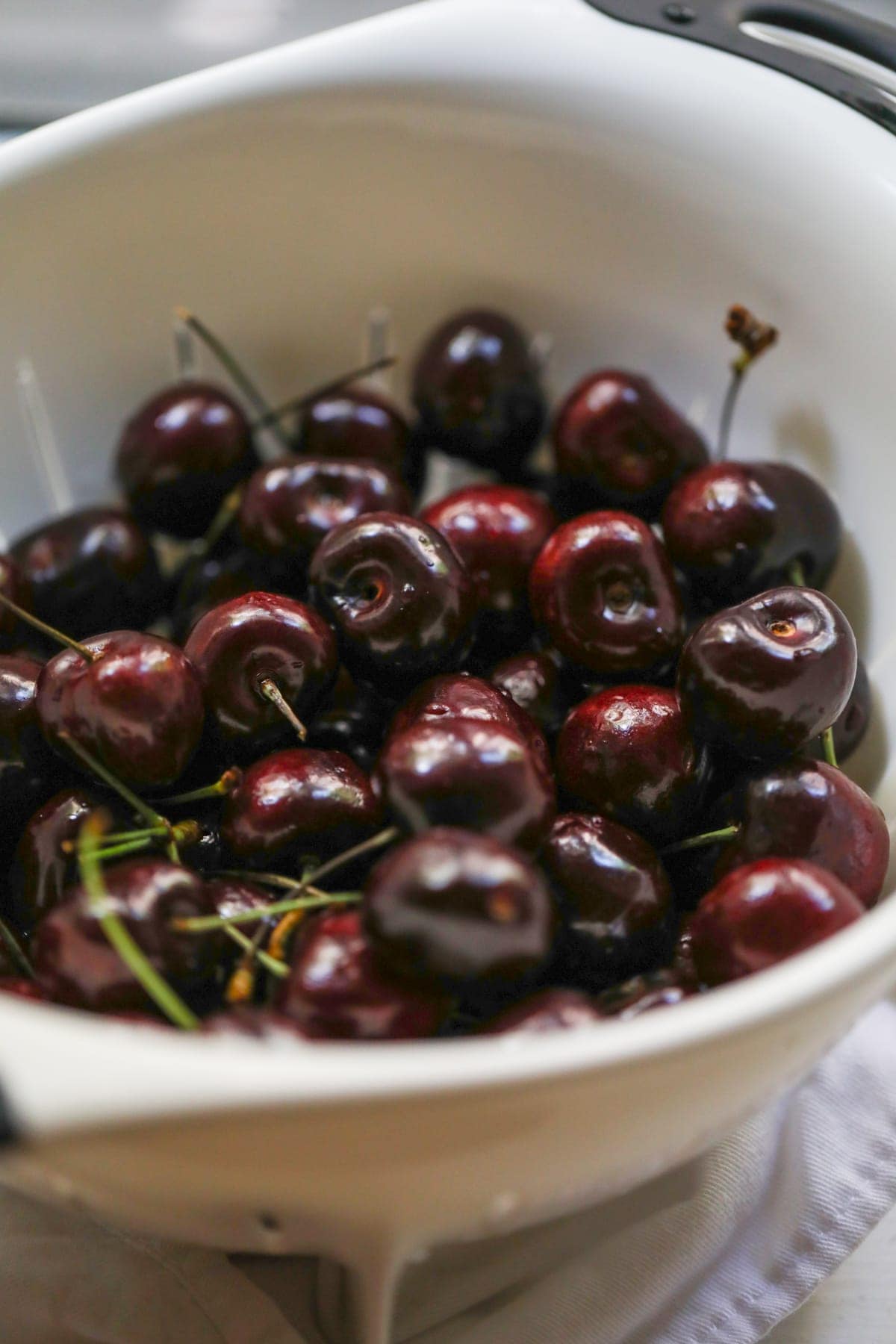 A close up of a bowl of cherries