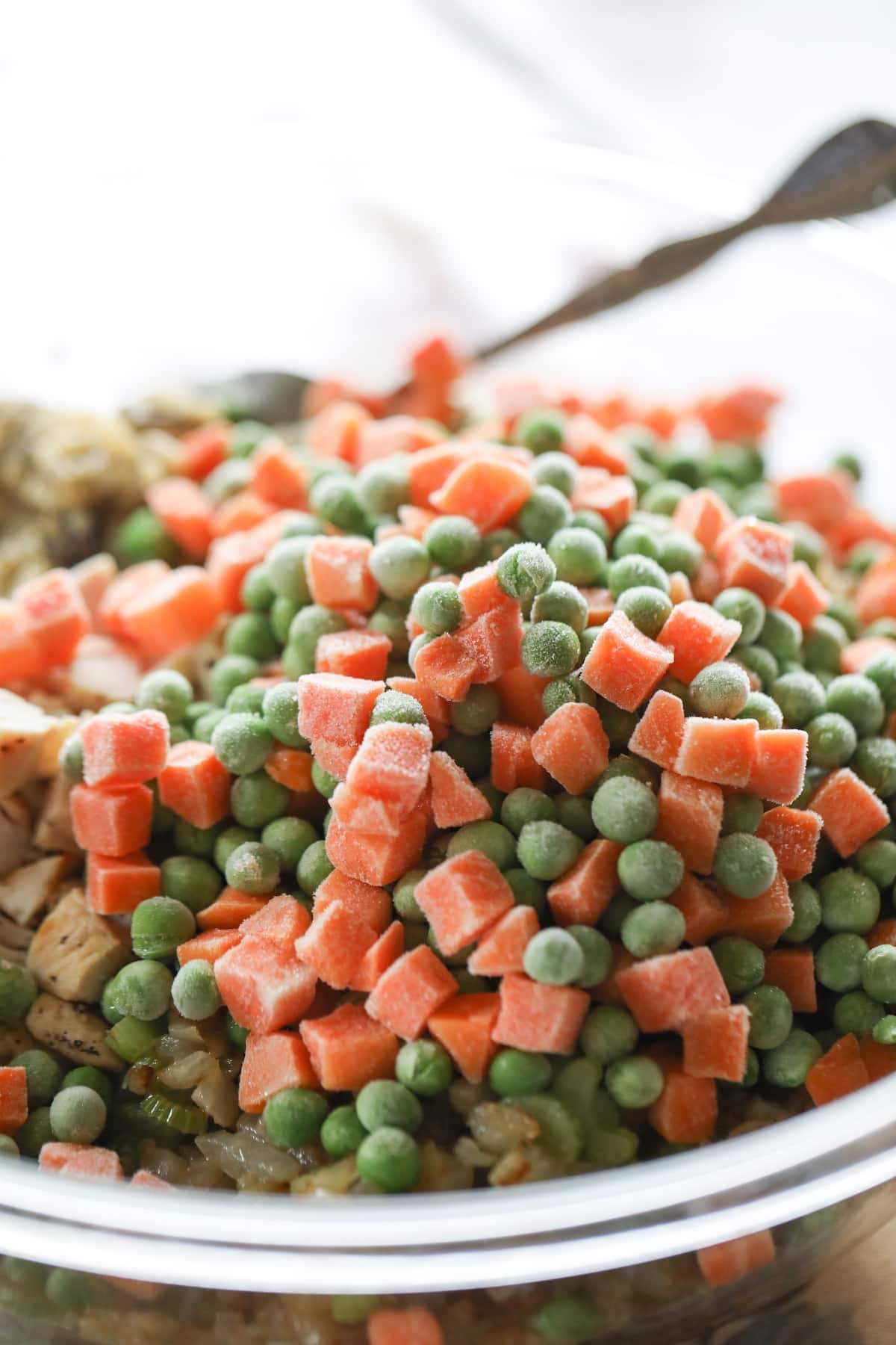 frozen peas and carrots added into bowl for casserole
