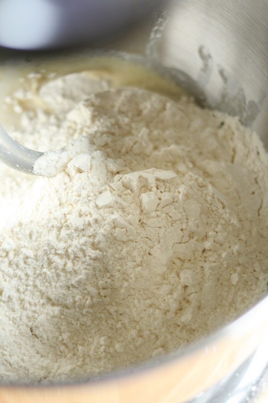 adding flour to dough