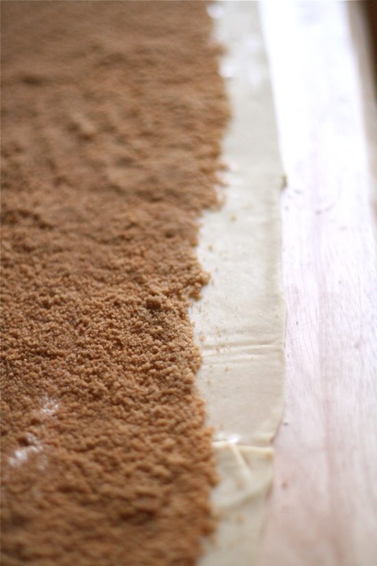 cinnamon sugar spread across rolled out dough