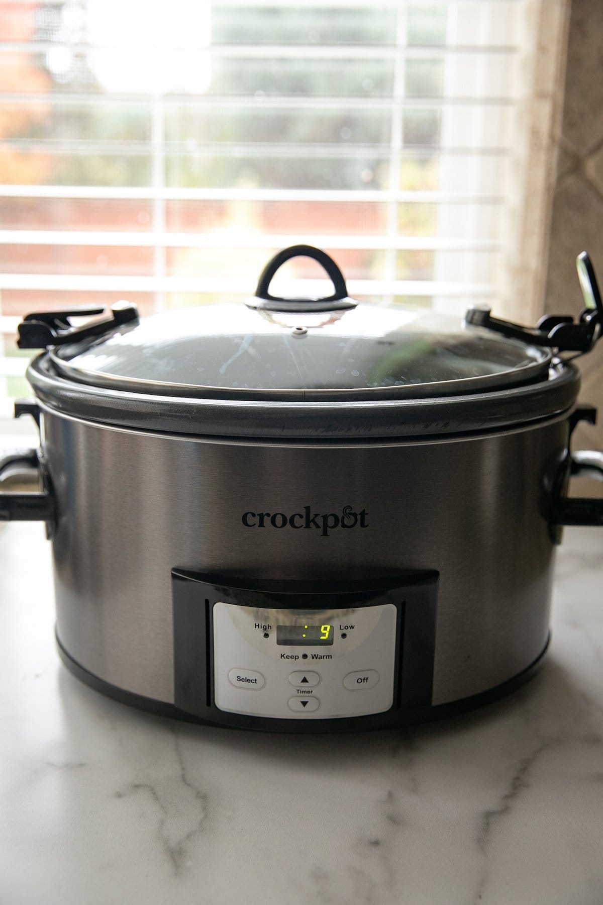 slow cooker with the lid on, on a counter