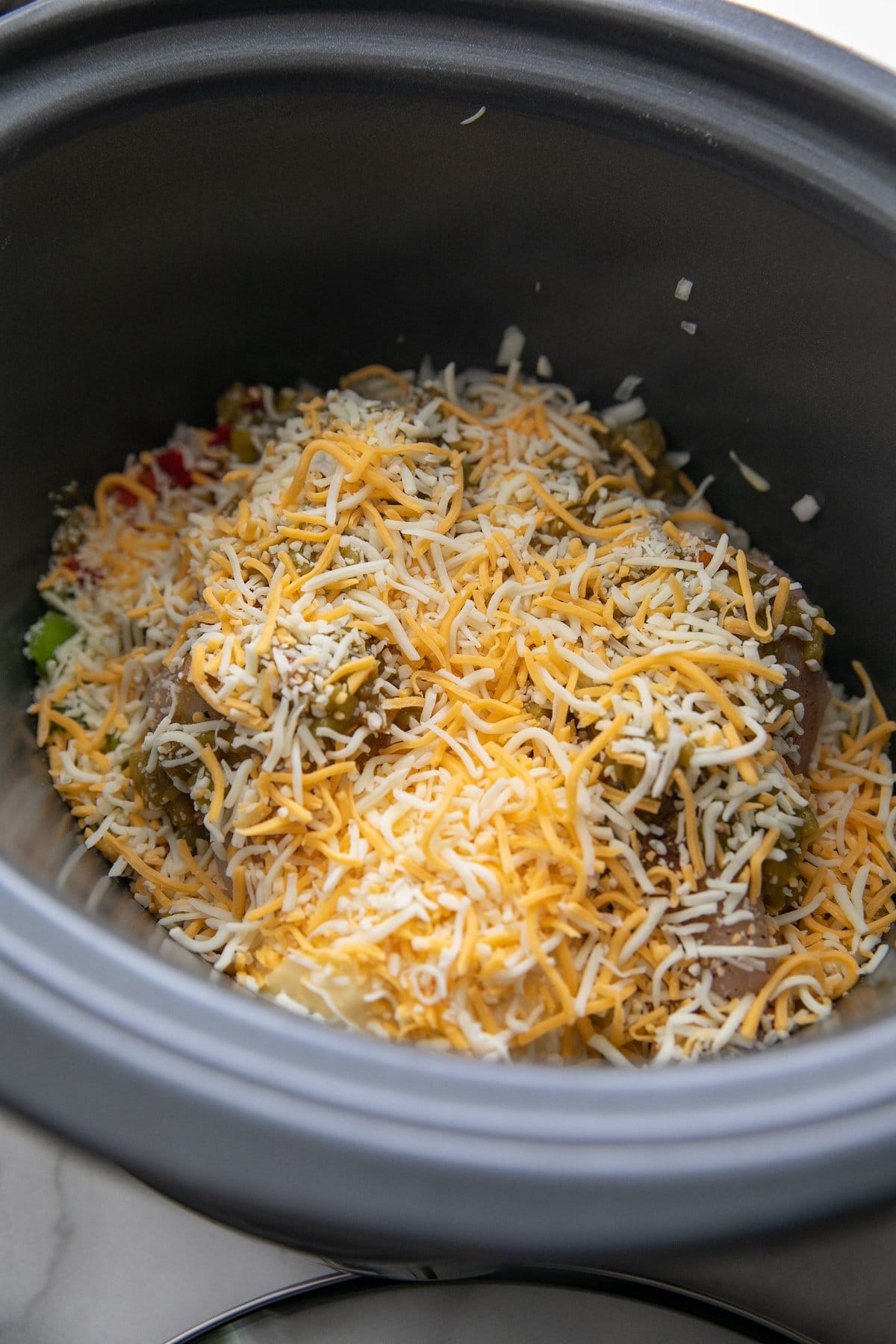 shredded cheese topping all other ingredients in a slow cooker