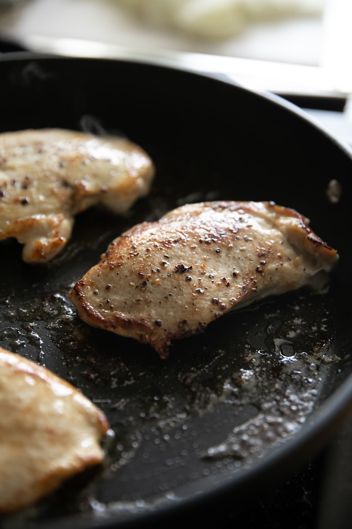 cooking chicken breasts in a pan