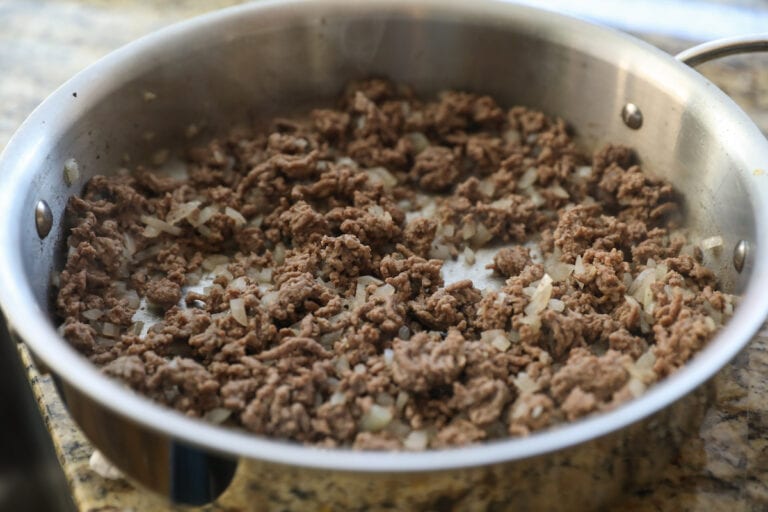 cooked ground beef and onions in skillet