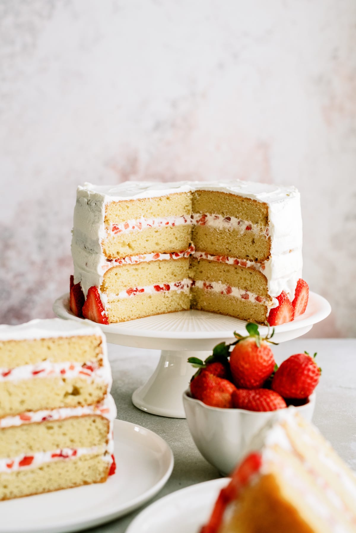 strawberry cake with slices on plates