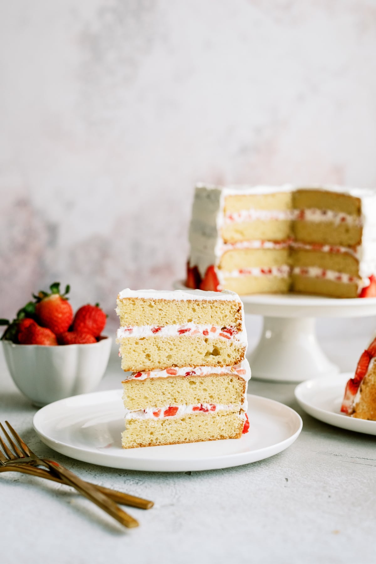 strawberry cake with a slice on plate