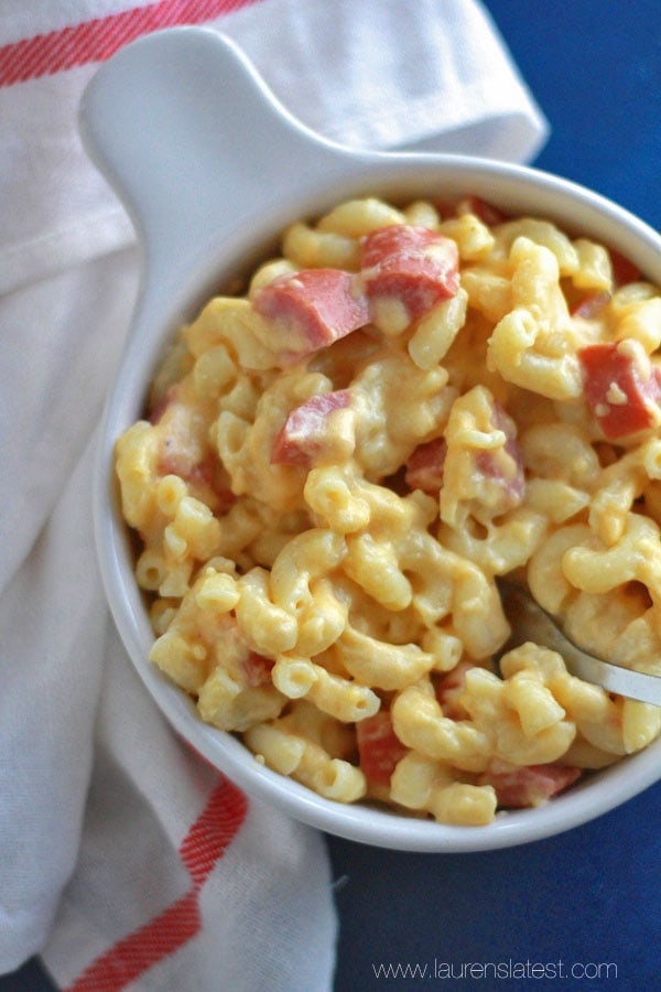 smoked sausage mac and cheese in a white bowl
