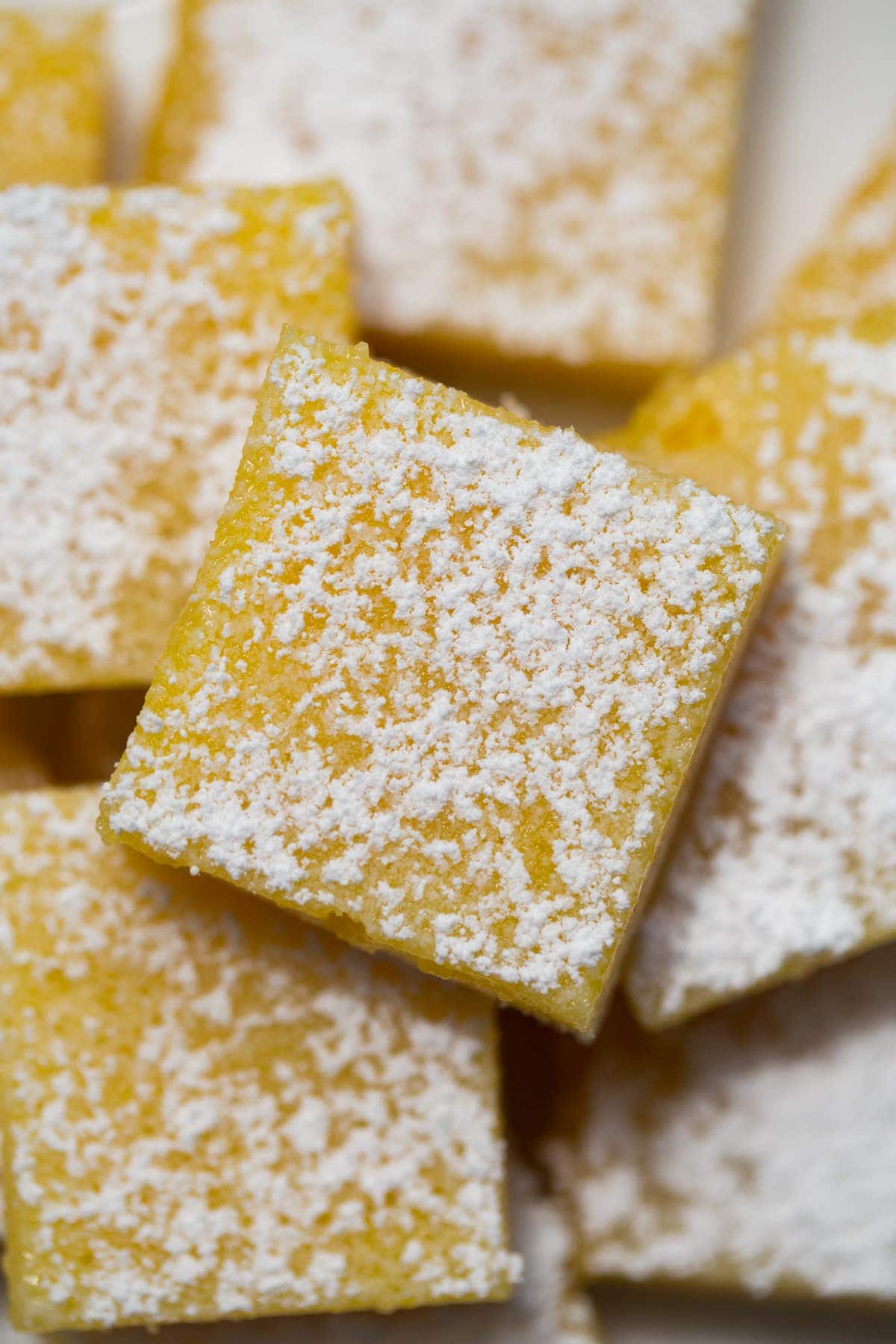 top down view of lemon bars on a white plate
