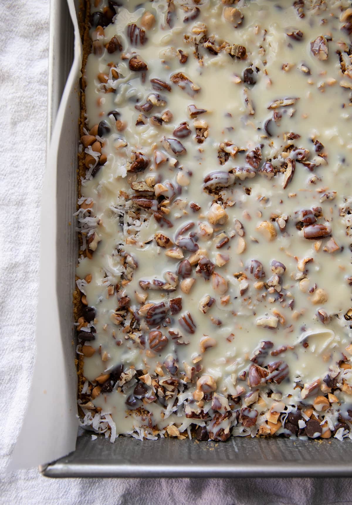 unbaked magic bars in a baking pan
