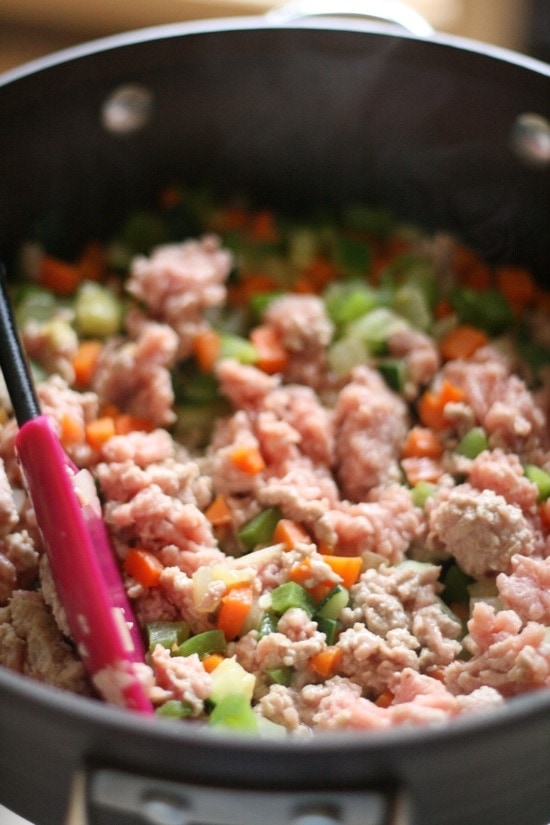 adding ground turkey to cooked vegetables