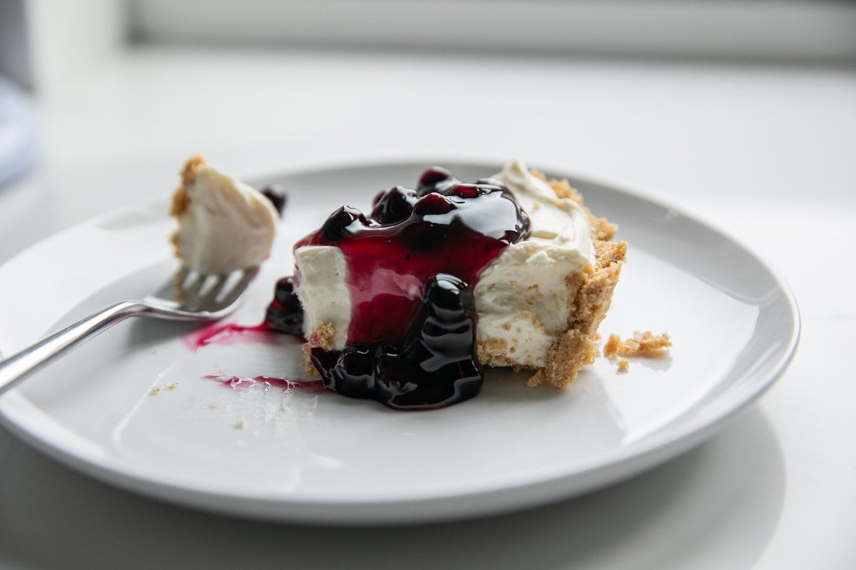 slice of no bake blueberry cheesecake on plate