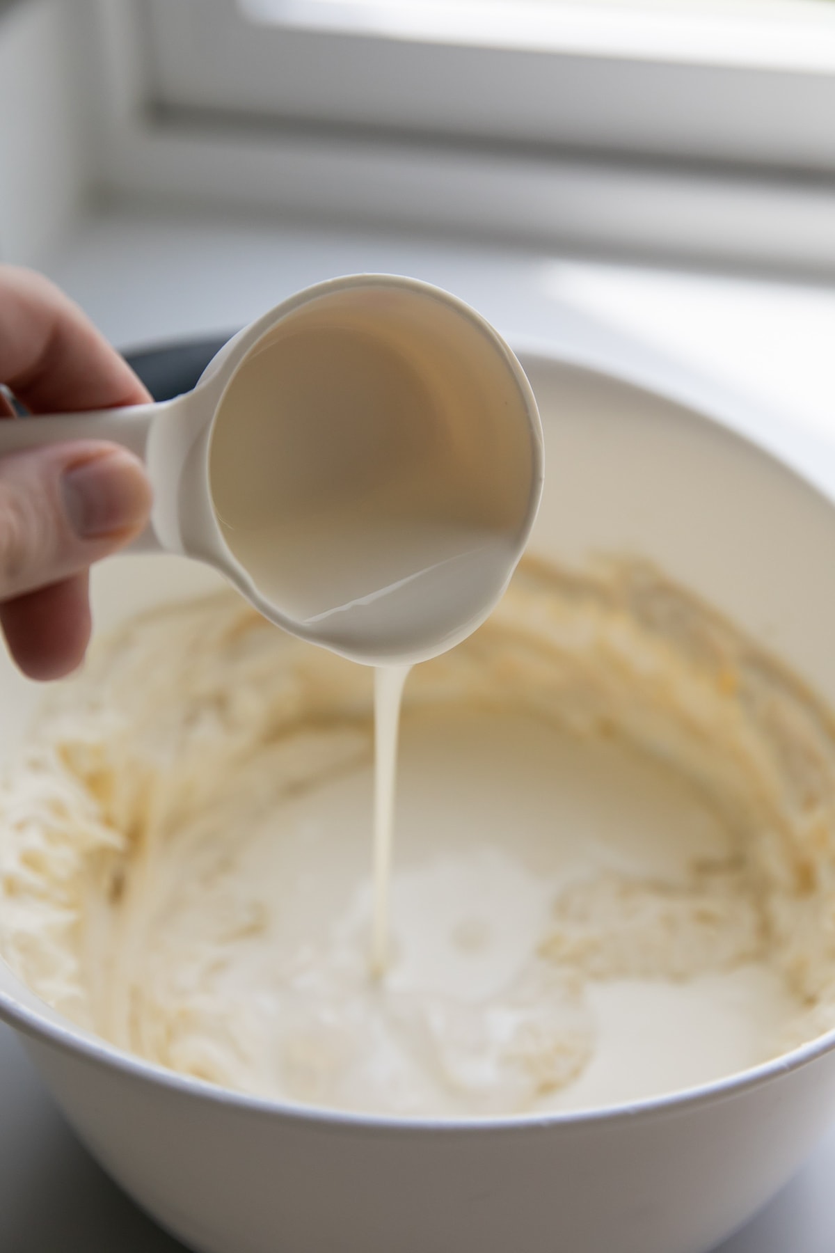 pouring cream into bowl