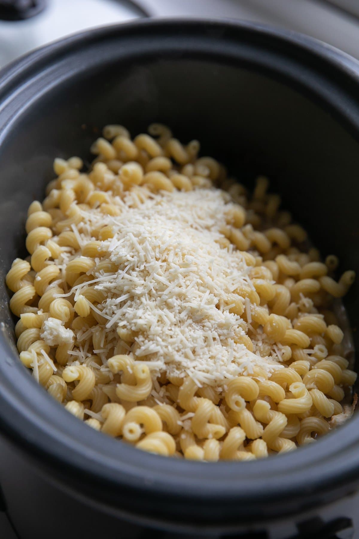 pasta and parmesan cheese in crockpot