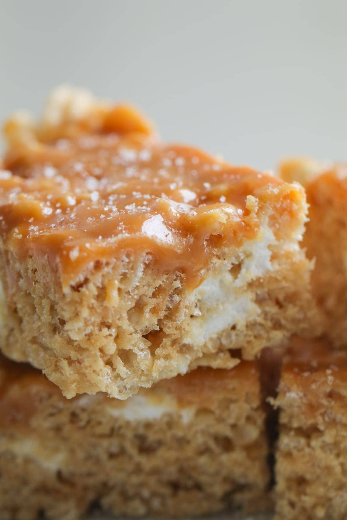 Salted Caramel Peanut Butter Rice Krispie Treats stacked on top of each other
