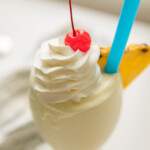 pina colada recipe in cup with straw