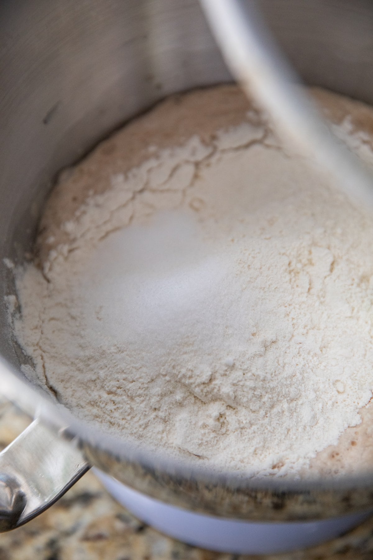 adding dry ingredients to pizza dough