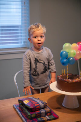 baby with chocolate birthday cake