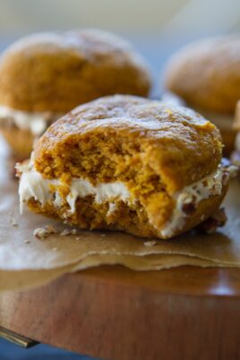 A pumpkin whoopie pie with a bite taken out