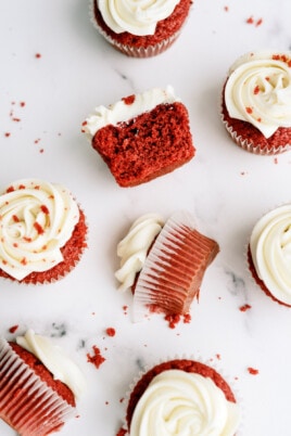 red velvet cupcakes on a white background. some of them are broken in half