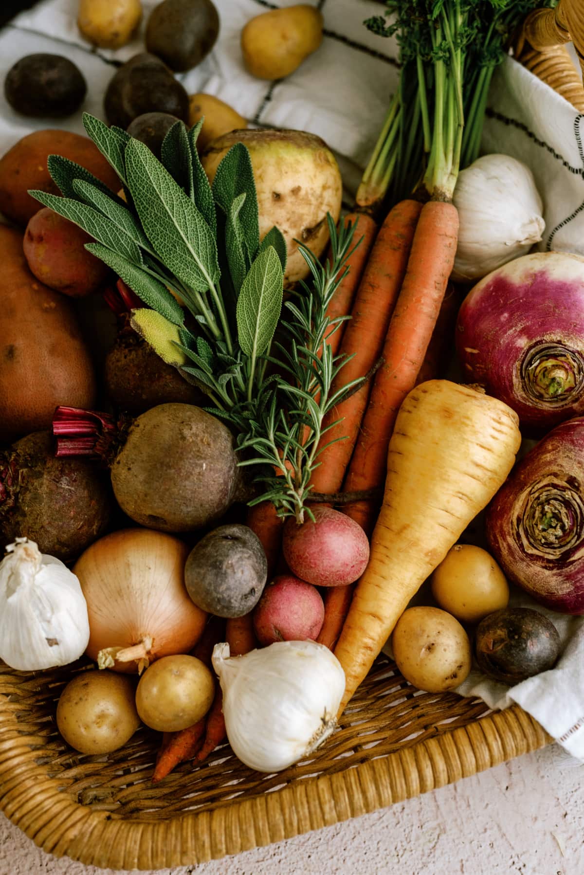 raw root vegetables on basket tray