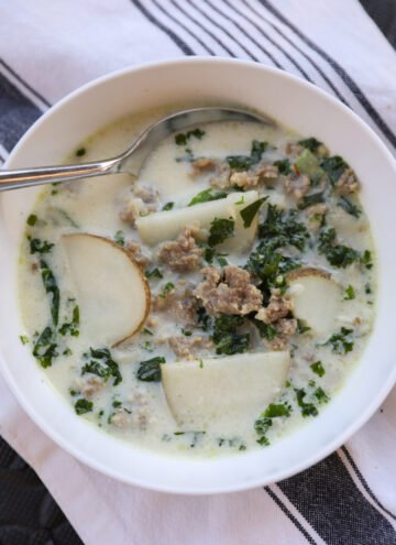 sausage kale soup in white bowl