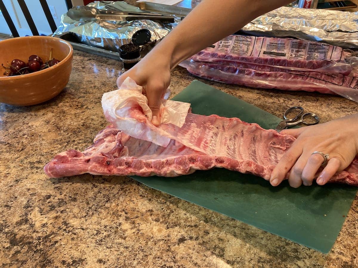 Raw rack of ribs on a cutting board