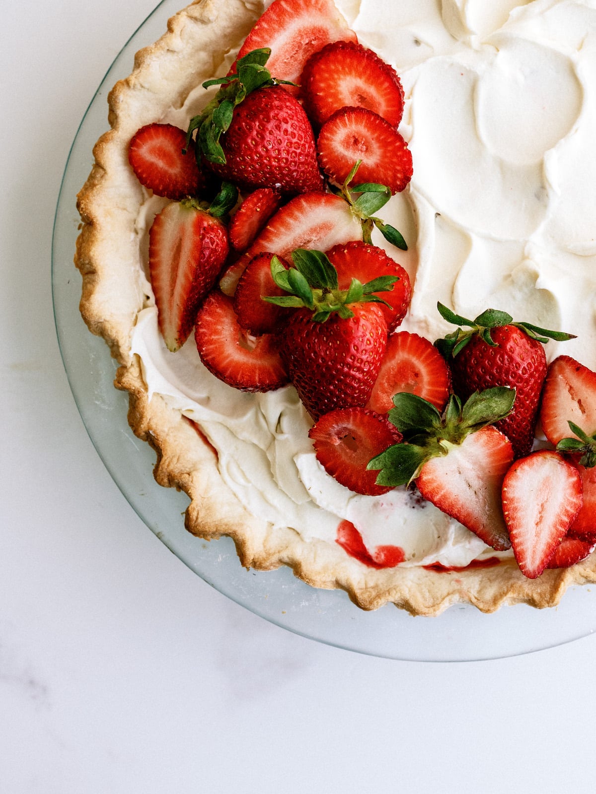 strawberry pie with jello and whipped cream on top