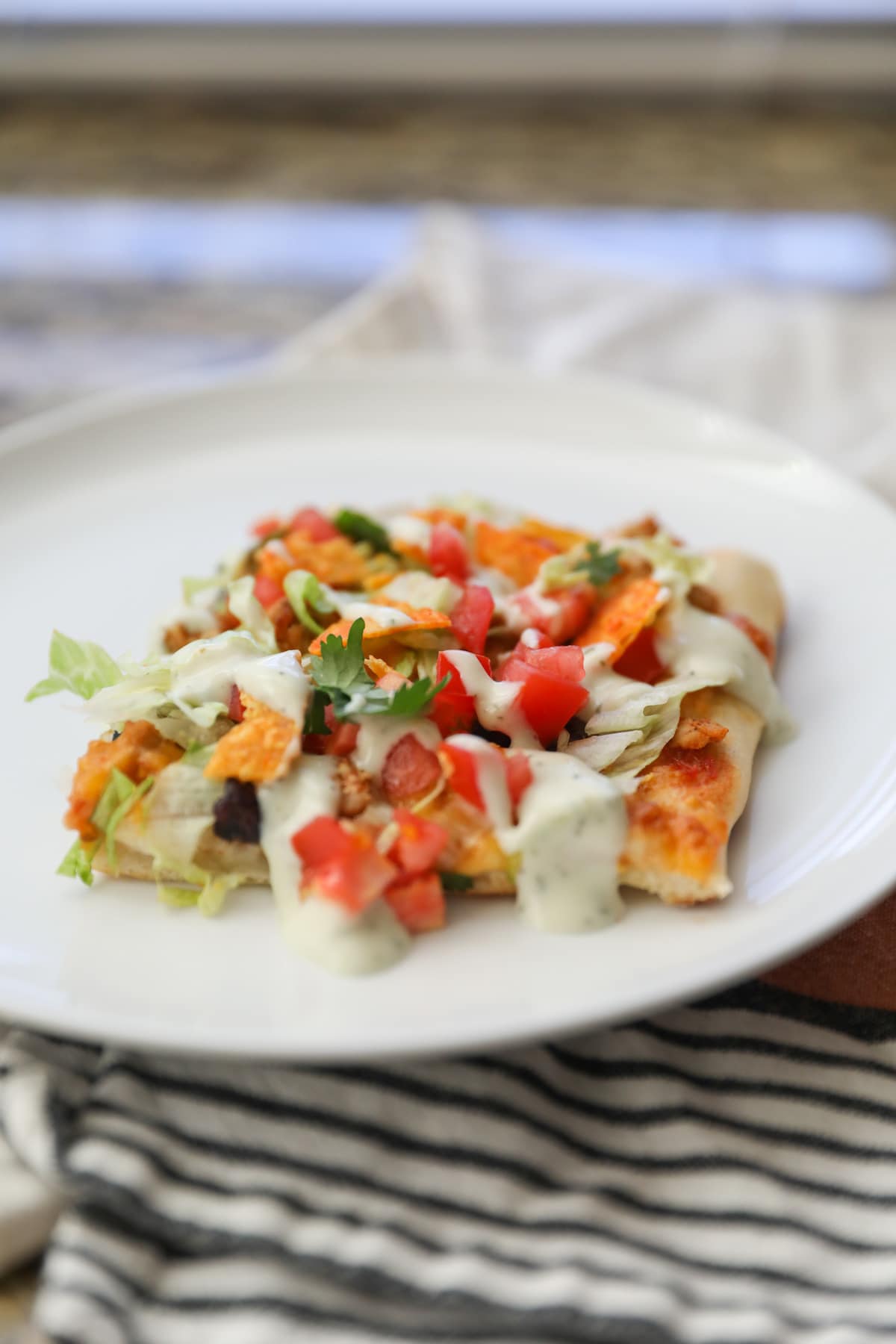 slice of taco pizza on white plate
